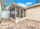 The screened porch and an adjacent patio made of red-brick pavers at 310 Sunvista Ct, Sanford, FL 32773