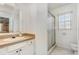 Clean bathroom with a single vanity, mirror, and glass-enclosed shower at 314 Silk Oak Dr, Kissimmee, FL 34743