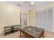 Neutral bedroom with a decorative ceiling fan, closets, and view into en suite bathroom at 314 Silk Oak Dr, Kissimmee, FL 34743