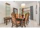 Formal dining room featuring tiled floors, a large chandelier, and patio door access at 314 Silk Oak Dr, Kissimmee, FL 34743