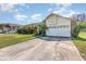 Inviting two-story home with a brick facade, a spacious two-car garage, and a concrete driveway at 314 Silk Oak Dr, Kissimmee, FL 34743