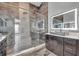 Updated bathroom featuring a large glass shower, modern tile, contemporary vanity and wood-look tile floors at 3664 Sickle St, Orlando, FL 32812