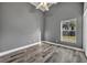 This bedroom features wood-look flooring, a ceiling fan, and a window letting in plenty of natural light at 3664 Sickle St, Orlando, FL 32812