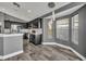 Modern kitchen with gray cabinets, stainless steel appliances, a breakfast nook, and wood-look tile flooring at 3664 Sickle St, Orlando, FL 32812