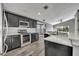 Well-equipped kitchen featuring dark cabinets, stainless steel appliances, and modern countertops at 3664 Sickle St, Orlando, FL 32812