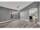 Open-concept floorplan from living room with wood-look floors looking into the open kitchen space at 3664 Sickle St, Orlando, FL 32812