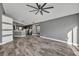 Bright living area featuring wood-look tile flooring, gray walls, and open space at 3664 Sickle St, Orlando, FL 32812