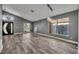 Spacious living room with vaulted ceiling and gray walls featuring modern light fixture and wood-look floors at 3664 Sickle St, Orlando, FL 32812