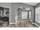 Main bedroom with wood-look tile flooring, gray walls, large closet and open doorway to the en-suite bathroom at 3664 Sickle St, Orlando, FL 32812