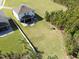 Aerial view of a backyard featuring a large lawn, covered patio, and a playset nestled against a wooded area at 3916 Clipstone Pl, Sanford, FL 32773