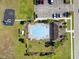 Aerial view of community pool, playground, parking and manicured green space offering residents leisure and convenience at 3916 Clipstone Pl, Sanford, FL 32773