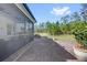 Backyard showcasing a screened patio, picnic table, and lush green lawn with tall trees at 3916 Clipstone Pl, Sanford, FL 32773