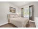 Cozy bedroom with natural light, neutral decor, and hardwood floors at 3916 Clipstone Pl, Sanford, FL 32773