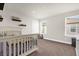 Bright Bedroom with a white crib, natural light, and neutral walls for versatile decorating at 3916 Clipstone Pl, Sanford, FL 32773