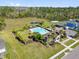 Aerial view of a community pool with palm trees, lounge chairs, and ample parking surrounded by lush landscaping at 3916 Clipstone Pl, Sanford, FL 32773