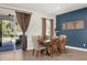 Dining room with a wood table, backyard view, and modern decor at 3916 Clipstone Pl, Sanford, FL 32773