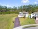 Lovely two-story home with a brick paver driveway, well-manicured lawn, and mature landscaping adding visual interest at 3916 Clipstone Pl, Sanford, FL 32773