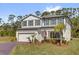 Inviting two-story home featuring well-manicured front yard, a two car garage, and a beautiful green lawn at 3916 Clipstone Pl, Sanford, FL 32773