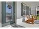 Close-up of a cozy front porch with rocking chairs and a decorative wreath on the front door at 3916 Clipstone Pl, Sanford, FL 32773