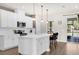 Bright and open kitchen featuring white cabinetry, a quartz countertop, stainless steel appliances and pendant lighting at 3916 Clipstone Pl, Sanford, FL 32773