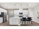 Spacious kitchen featuring a center island with seating, stainless appliances, and sleek white cabinets at 3916 Clipstone Pl, Sanford, FL 32773