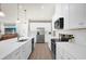 Bright kitchen featuring stainless steel appliances, white cabinets, a large island and pendant lighting at 3916 Clipstone Pl, Sanford, FL 32773