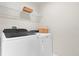 Laundry room with a modern washer and dryer, and wire rack shelving at 3916 Clipstone Pl, Sanford, FL 32773