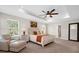 Bright main bedroom with a tray ceiling, ceiling fan, and en-suite bathroom at 3916 Clipstone Pl, Sanford, FL 32773