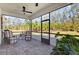 Inviting screened patio with comfortable seating and views of a lush green backyard at 3916 Clipstone Pl, Sanford, FL 32773