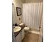 Cozy bathroom featuring a shower with tub, and a sink with dark countertop at 547 Madina Cir, Davenport, FL 33837