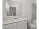 Bright bathroom features a white vanity, undermount sink, and tile accents at 6068 Peaceful Pkwy, Clermont, FL 34714