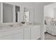 Well-lit bathroom with double vanity, quartz countertops, and white cabinetry at 6068 Peaceful Pkwy, Clermont, FL 34714