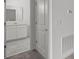 Hallway view of a bathroom with a white vanity and tiled floors at 6068 Peaceful Pkwy, Clermont, FL 34714