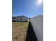 Wide backyard featuring a well-kept lawn, a secure white fence, and mature landscaping at 622 Samuel Pl, Davenport, FL 33837