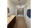 Bathroom featuring double sinks, granite countertops, and a tiled shower at 622 Samuel Pl, Davenport, FL 33837