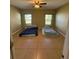 Neutral bedroom with bright windows showcasing flooring and a ceiling fan at 622 Samuel Pl, Davenport, FL 33837