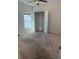 This bedroom features neutral carpeting, a ceiling fan, a window for natural light, and a convenient closet at 622 Samuel Pl, Davenport, FL 33837