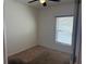 Bedroom with neutral carpeting, a ceiling fan, and a window letting in natural light at 622 Samuel Pl, Davenport, FL 33837