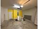 Spacious garage with yellow accent wall at 622 Samuel Pl, Davenport, FL 33837