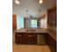 Kitchen island with sink, dishwasher, and granite countertop at 622 Samuel Pl, Davenport, FL 33837