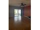 The living room features tile flooring, a ceiling fan, and sliding doors leading to a screened patio at 622 Samuel Pl, Davenport, FL 33837