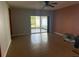 The living room features tile flooring, a ceiling fan, and sliding doors leading to a screened patio at 622 Samuel Pl, Davenport, FL 33837