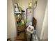 Utility room featuring water heater, shelving, and essential storage solutions at 622 Samuel Pl, Davenport, FL 33837