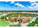 A beautiful aerial view of the community clubhouse, pool and surrounding neighborhood at 7587 Oakmoss Loop, Davenport, FL 33837