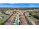 Expansive aerial view of the neighborhood with houses, roadways, and water features at 7587 Oakmoss Loop, Davenport, FL 33837