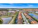 Beautiful aerial view of a vibrant community with lakes and well-maintained homes under a clear blue sky at 7587 Oakmoss Loop, Davenport, FL 33837