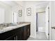 Bright bathroom featuring double sink vanity and walk in shower at 7587 Oakmoss Loop, Davenport, FL 33837