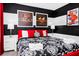 Bedroom featuring a bed with black and white bedding and modern art on the walls at 7587 Oakmoss Loop, Davenport, FL 33837