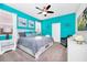 Brightly colored bedroom featuring a ceiling fan, neutral carpet and a large window for lots of natural light at 7587 Oakmoss Loop, Davenport, FL 33837