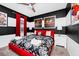 Bright bedroom with a red frame bed, black and white bedding, and stylish decor at 7587 Oakmoss Loop, Davenport, FL 33837